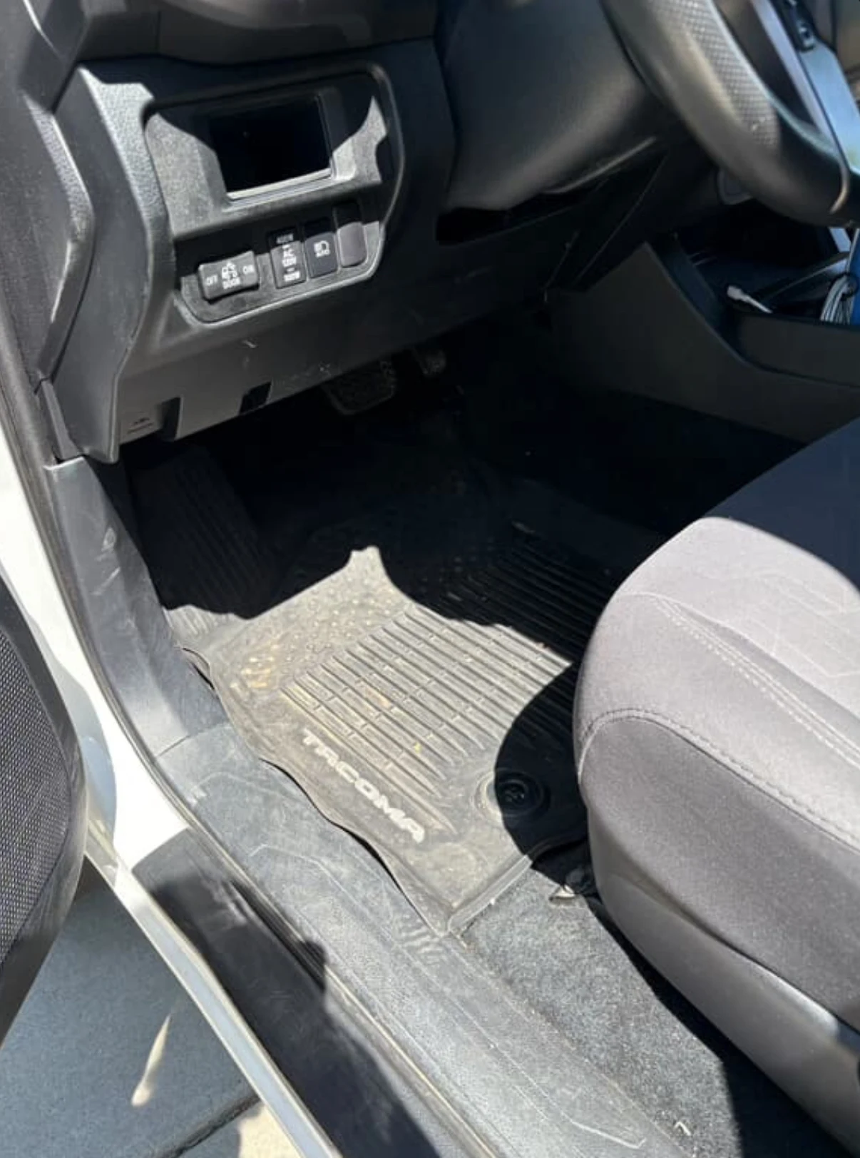 Dusty dirty car interior before hospital-grade steam cleaning and auto interior cleaning service in Syracuse Utah