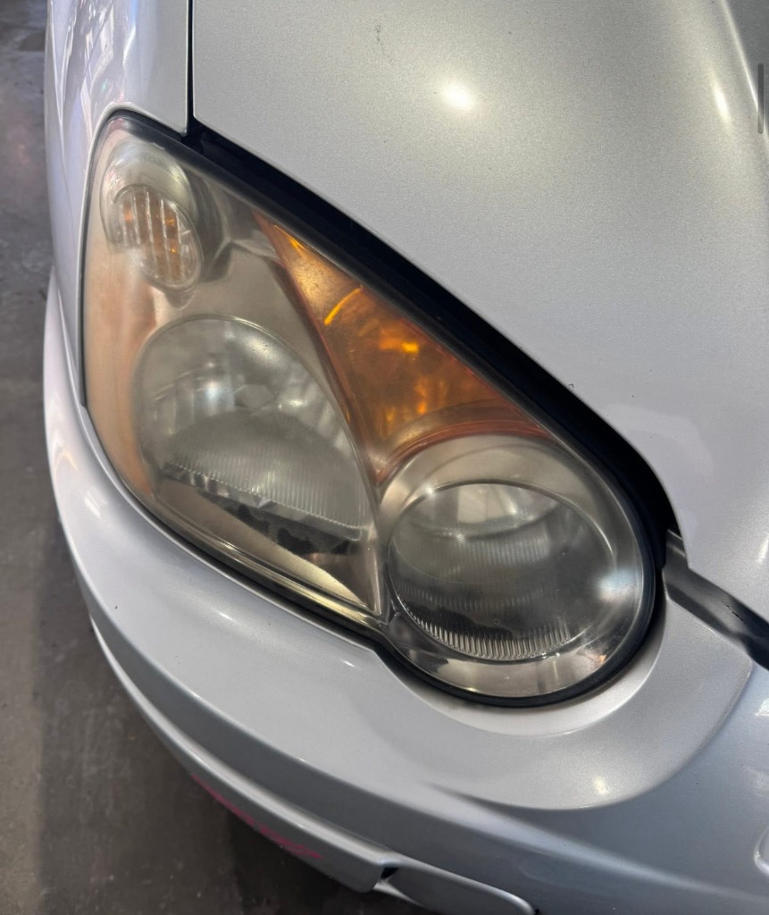 Yellow foggy and oxidized car headlight reducing visibility in Northern Utah winters