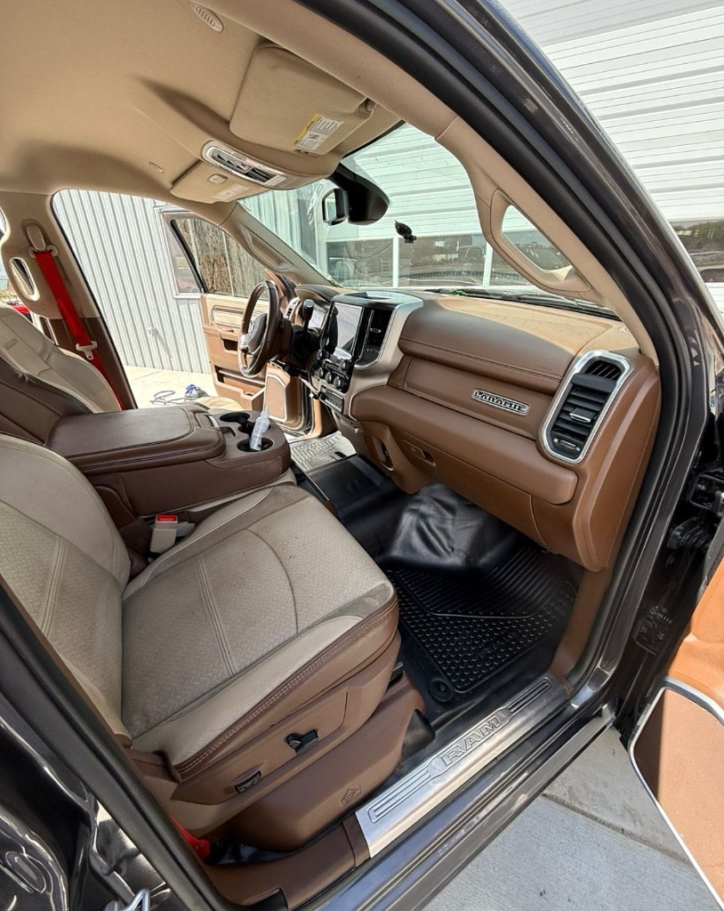 Spotless Ram Laramie interior with clean leather and conditioned dashboard in Roy Utah