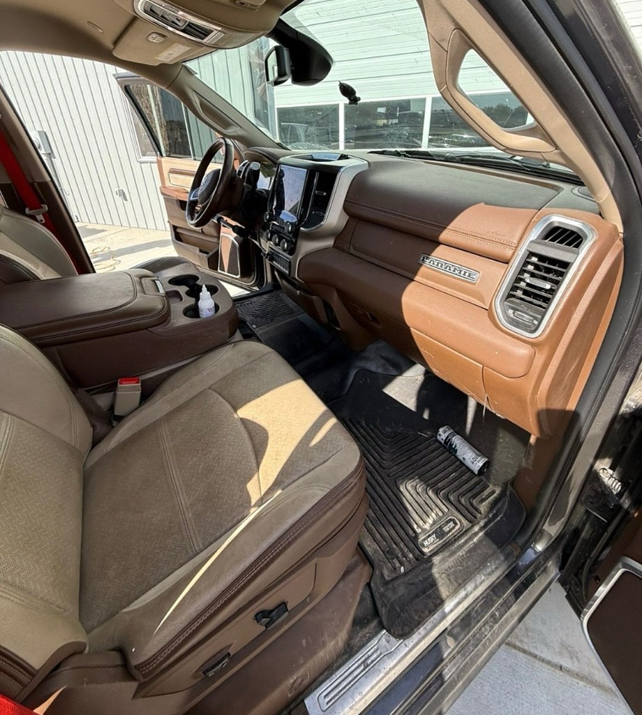 Dusty Ram Laramie truck interior with dirty floor mats before professional detailing in Roy